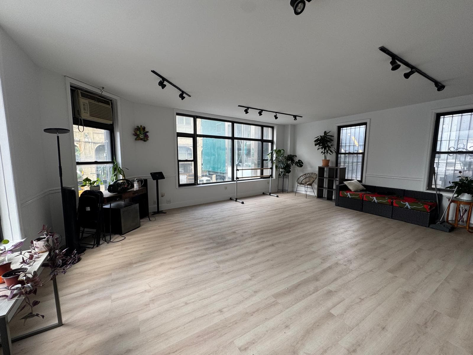 Open wood studio floor with natural light and a lounge area